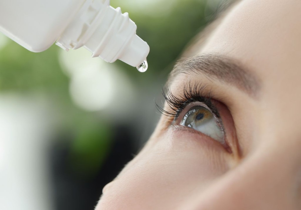 Lubricating eye drop being applied for dry-eye relief