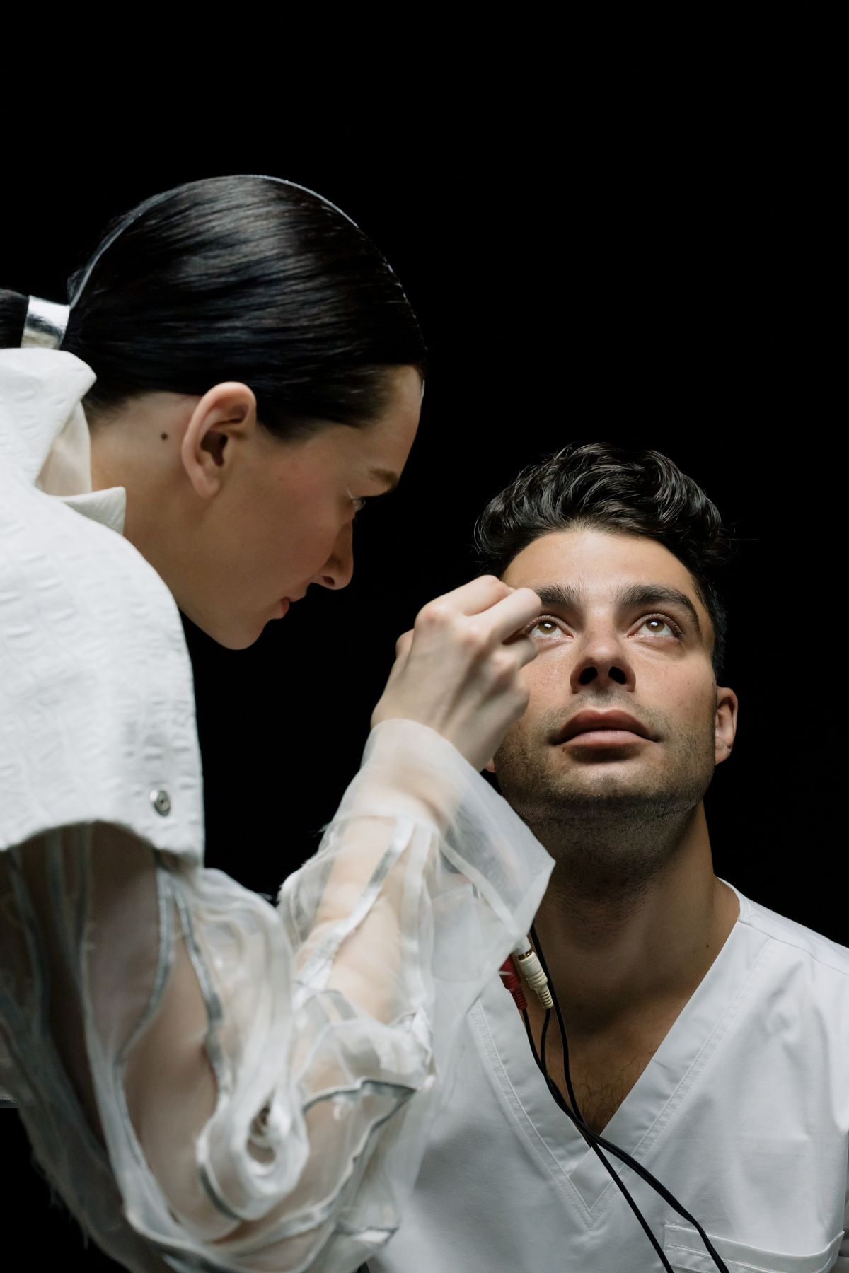 Eye specialist performing a close clinical eye examination